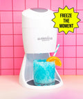 Sturdy Electric Shaved Ice Machine And Sno Cone Maker For Home, white countertop unit with blue snow cone and orange slice.