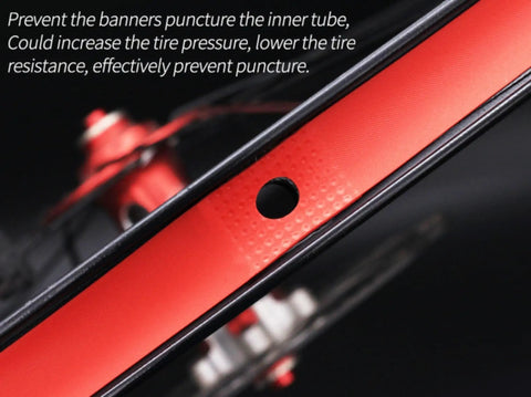 Close-up of heavy duty rim tape strip liner for mountain bike, 26 inch red, nylon construction, showing spoke hole protection.