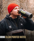 Person using GeoPress 24 Oz Water Purifier Bottle For Hiking And Camping, Ultimate Survival Filter For Travel, in Black Camo