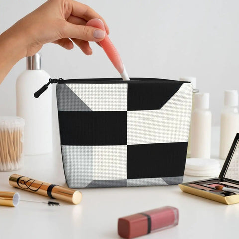 Level Up Your Packing Game With This Legit Black And White Piano Grid Print Large Toiletry Bag Crafted From Water Repellent Polyester Fabric For Hassle Free Travel Essentials And Cosmetics. Hand reaching for cosmetics in stylish black and white grid print toiletry bag.