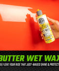 Hand holding Butter Wet Wax from 14 Piece Car Wash Arsenal Builder Kit with Foam Blaster Wash Bucket Towels Applicators and 16 oz soaps.