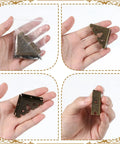 Antique Bronze Metal Corner Protectors Set Of 8 Decorative Brackets shown in hand for wood projects