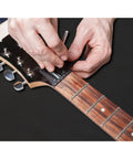 Hands adjusting a guitar with All In One Guitar Repair Kit With Neck Rest Cradle And Pro Grade Gig Ready Work Mat For Studio And Shop