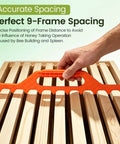 Hand holding orange Beekeeping Frame Spacers 2 Pack 9 Frame Spacer Tool For Beehive Boxes, ensuring precise frame spacing.