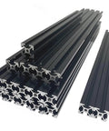 Built Tough Black Extrusion Frame Kit For 3D Printers With Reliable Blind Joints And Sturdy Aluminum Profiles showcases stacked black aluminum profile bars.