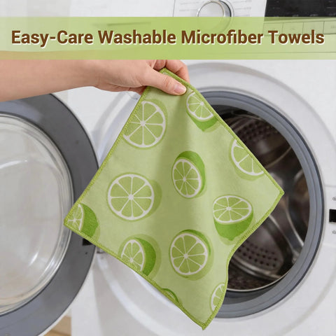 Microfiber cleaning cloth with lime/lemon print, green, held by hand beside a front-loading washer