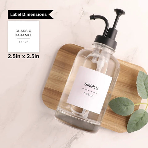 Two Pack Glass Syrup Pump Dispensers For Coffee Bar Setup with label and matte black pump on wooden board
