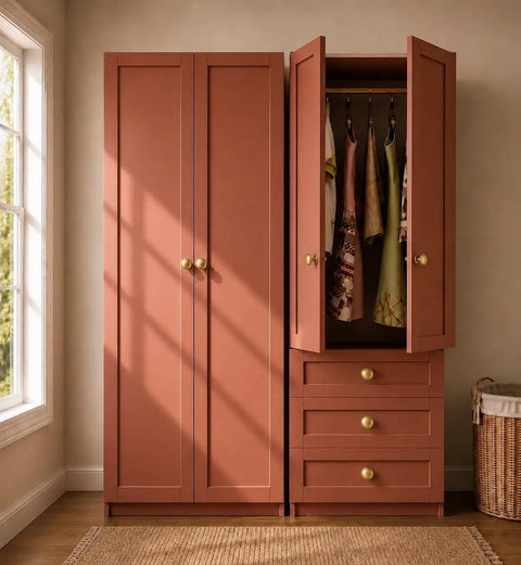 Brushed Satin Gold Wide Base Bifold Closet Door Knobs 4 Pack on terracotta cabinet with open wardrobe and dresses.