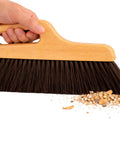 Hand holding Hand Finish Concrete Brush 12 Inch Horsehair Bristles 3 Inch Trim Angled Handle For Smooth Precise Concrete Finishing