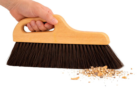 Hand holding Hand Finish Concrete Brush 12 Inch Horsehair Bristles 3 Inch Trim Angled Handle For Smooth Precise Concrete Finishing