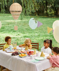 Rattan Hot Air Balloon Decor Set 2 Pcs Wicker Basket Ornaments hanging above picnic table in garden during baby shower.