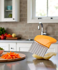 Orange-handled vegetable crinkle cutter with stainless steel wavy blade for home kitchen.