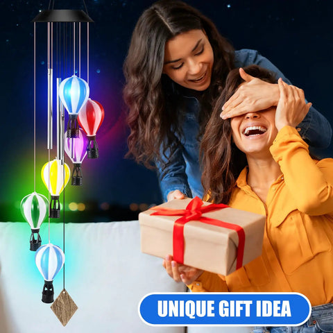 Woman gifting Solar Wind Chimes Outdoor Decor With Hot Air Balloon Lights Waterproof Garden Patio Lighting Lit At Night.