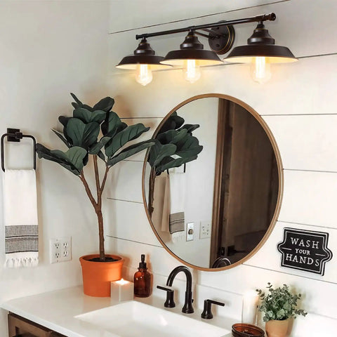 Industrial Rustic 3 Light Vanity Wall Sconce in Dark Bronze with Vintage Gold Trim above bathroom mirror