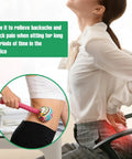 Woman using Two Piece Long Herbal Massage Hammer for lymphatic drainage and back muscle relief in an office setting.