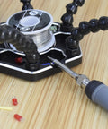 Pro Grade Helping Hands Third Hand Soldering Station with four magnetic arms and soldering iron on wood surface