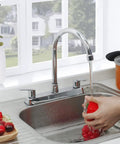 Heavy Duty Two Handle Kitchen Sink Faucet Slick Chrome Finish 360 Swivel High Arch Design Three Hole Deck Mount Tap in action rinsing vegetables.