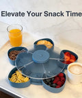 Rotating 5-Compartment Snack Tray With Lid displaying fruit, cookies, and drinks on a kitchen table, blue Lazy Susan style organizer
