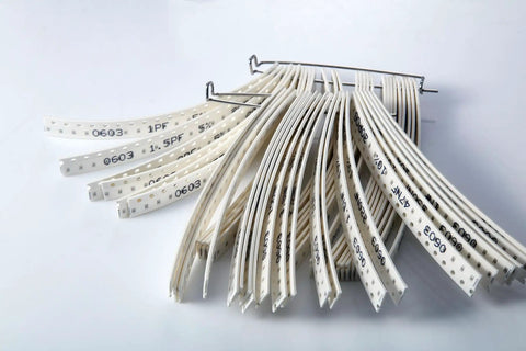 SMD Capacitor Kit 1000 Pieces 0603 Size Ceramic MLCC Assortment From 1pF To 10uF, 50 Values, 6.3V To 50V with labeled tape.