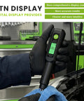 Heavy Duty Brake Fluid Tester Pen With Digital LCD Screen and Robust Metal Probe in use measuring moisture levels on a towel.