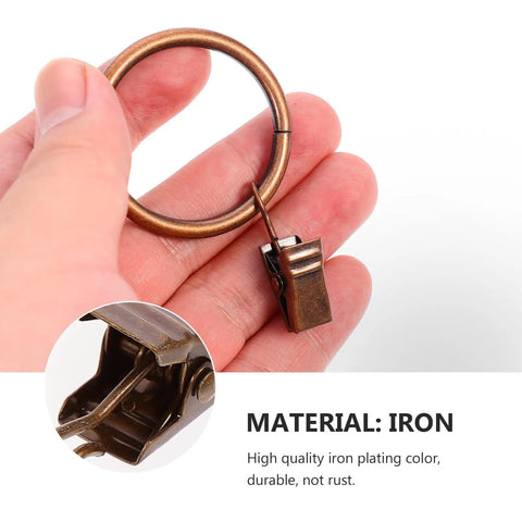 Close-up of 50 Pieces Vintage Bronze Shower Curtain Hooks With Hanging Clips And Glide Rings For Bathroom, in hand.