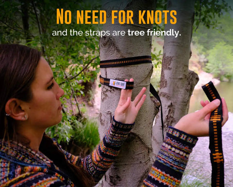 Person setting up Cozy Two Person Camping Hammock With Bug Net And Rain Fly Lightweight Double Parachute Nylon on tree straps