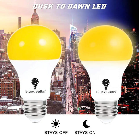 2 Pack LED Dusk To Dawn A19 Bug Light Bulbs With Automatic Sensor Yellow Amber Light For Porch Security Auto On Off 2000K E26 Base 500 Lumens No Fuss Install with cityscape background