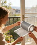 Person holding DIY Window Screen Repair Tape Waterproof Mesh Patch, showing roll and mesh texture, on a patio door screen.