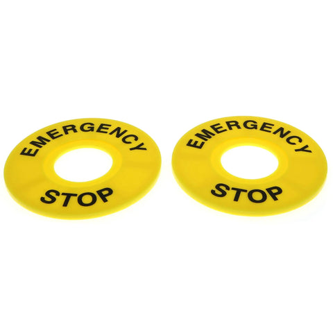 Yellow emergency stop labels for push button switches, used in industrial control panels and safety systems.