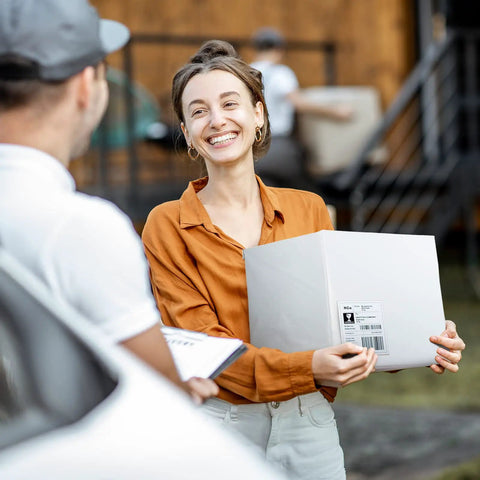 Woman receiving package, representative of White Poly Mailers 14.5 By 19 Inches, 100 Pack Self Seal Shipping Envelopes For Small Business Boutique And Clothing Packaging, Durable Opaque Waterproof Tamper Resistant Bags.