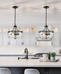 Firedanz 3-Light Glass Pendant Light, Height Adjustable hanging above a modern kitchen island with clear glass shades.