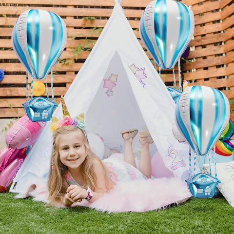 Girl posing with 4D Hot Air Balloon Mylar Foil Balloons 35 Inch Blue 4 Pack Helium Floating Decorations For Kids Birthday Party.