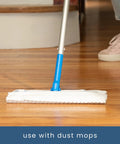 Flat mop with blue handle and white microfiber cleaning pad on wood floor