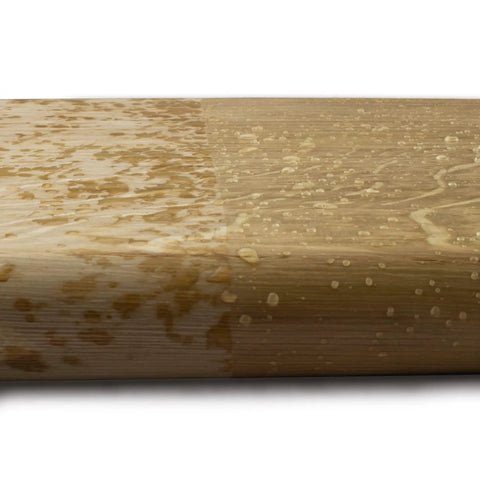 Premium Hard Wax Oil For Interior Wood Finishes All Natural Quick Drying Water Repellent Formula on a bamboo surface with water beads.