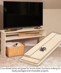 Universal Cross Dowel Jig Deluxe Kit Featuring Seven Heavy Duty Drill Guide Bushings For Bolts And Premium Wood Dowels with assembled TV stand.