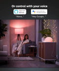 Woman in modern living room with Hue Smart Plug Turns Any Lamp Into a Smart Light with no fuss, Control Hands Free via the Hue App