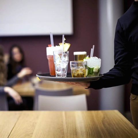 Waiter holding a tray with drinks in Stackable 12.5oz Glass Tumblers Set Of 6 For Sodas Juices Milk Beer And Spirits