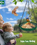 Hanging Bird Feeder For Outdoors 9 Inch Metal Mesh Tray Platform Perfect For Finches Chickadees Sparrows And Other Small Birds Green Backyard Feeder With Minimal Seed Waste And Easy Clean Design with birds and family in background