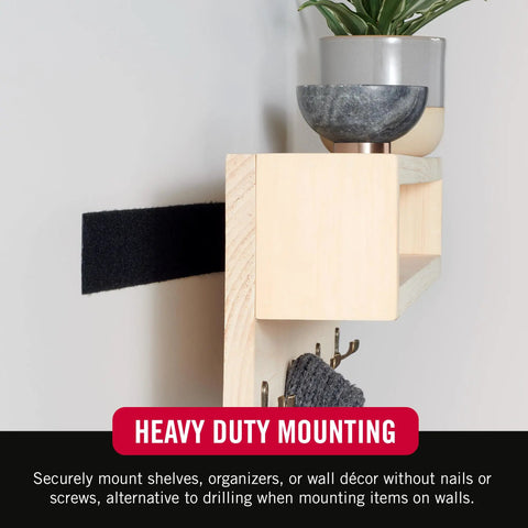 Heavy Duty Tape 12 Foot Roll Holds Up To 10 Lbs With Industrial Strength Adhesive For Indoor Or Outdoor Use No Tools Needed Works On Plastic Glass Metal Painted Wallboard One Half Inch Wide Black shown holding a shelf with plants.