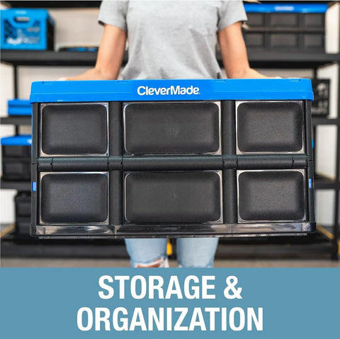 Person holding collapsed CleverMade Collapsible Storage Bins 3 Pack 46L in Royal Blue, stackable heavy duty crate.