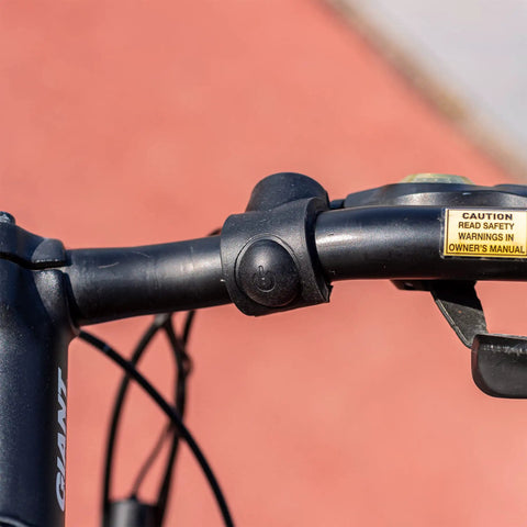 Close-up of 120dB Electric Bike Horn For Mountain And Road Bikes And Scooters mounted on bicycle handlebar