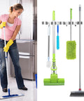 Woman mopping next to Heavy Duty Stainless Steel Broom Holder Wall Mount With Five Racks And Four Hooks Space Saving Mop Organizer