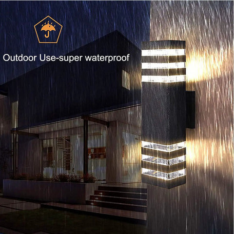 15 Inch LED Up And Down Outdoor Wall Light With Aluminum Housing 18W 4000K Day White IP65 shown in rain at night