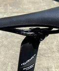 Side view of bike seat with Titanium Seatpost Ear Clamp Kit For Oval Carbon Rails 7x9 Bolt CNC Machined Aluminum Clamp Ritchey WCS