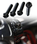 Top Shelf Titanium Handlebar Clamp Bolts And Brake Clutch Perch Screws For Heavy Duty Motorcycles close-up of four black titanium screws with a shiny clamp.