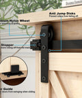 Close-up of 4 Foot Mini Bypass Barn Door Hardware Kit with anti-jump discs and nylon wheel on wooden cabinet door.