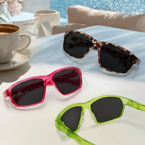 Heavy Duty Grind Ready Anti Fog Safety Glasses With Scratch Resistant Ruby Smoke Tint Polycarbonate Unisex Fit UV Shielding Real Deal Coverage For Any Task on table with coffee.