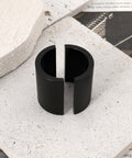 Close-up of black handlebar reducer from Pair Pit Bike Handlebar Reducers 28mm To 22mm Convert Fatbar To Seven Eighths Inch Riser Spacers