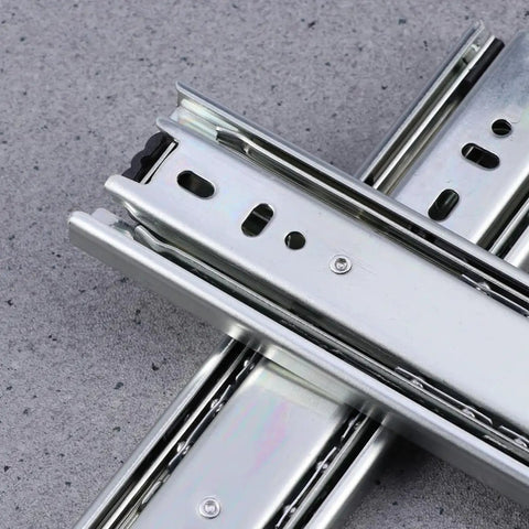 Two Pack Heavy Duty Steel Ball Bearing Drawer Slides With Buttery Smooth Gliding Action Built For Kitchen Storage Cabinets And Desk Pedestals Zero Fuss Telescopic Hardware Rails close-up of metal drawer slide tracks.