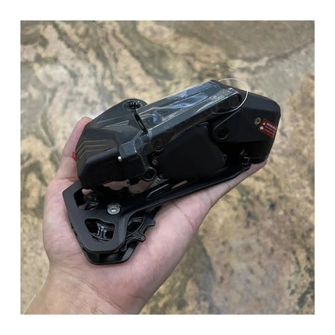 Person holding Wireless Electronic Groupset For Gravel Bikes With Hydraulic Disc Or Rim Brakes 3 To 14 Speed Range 75mm Shifter Spacing Wireless Shifter To Derailleur Communication Durable Gravel Ready Performance component